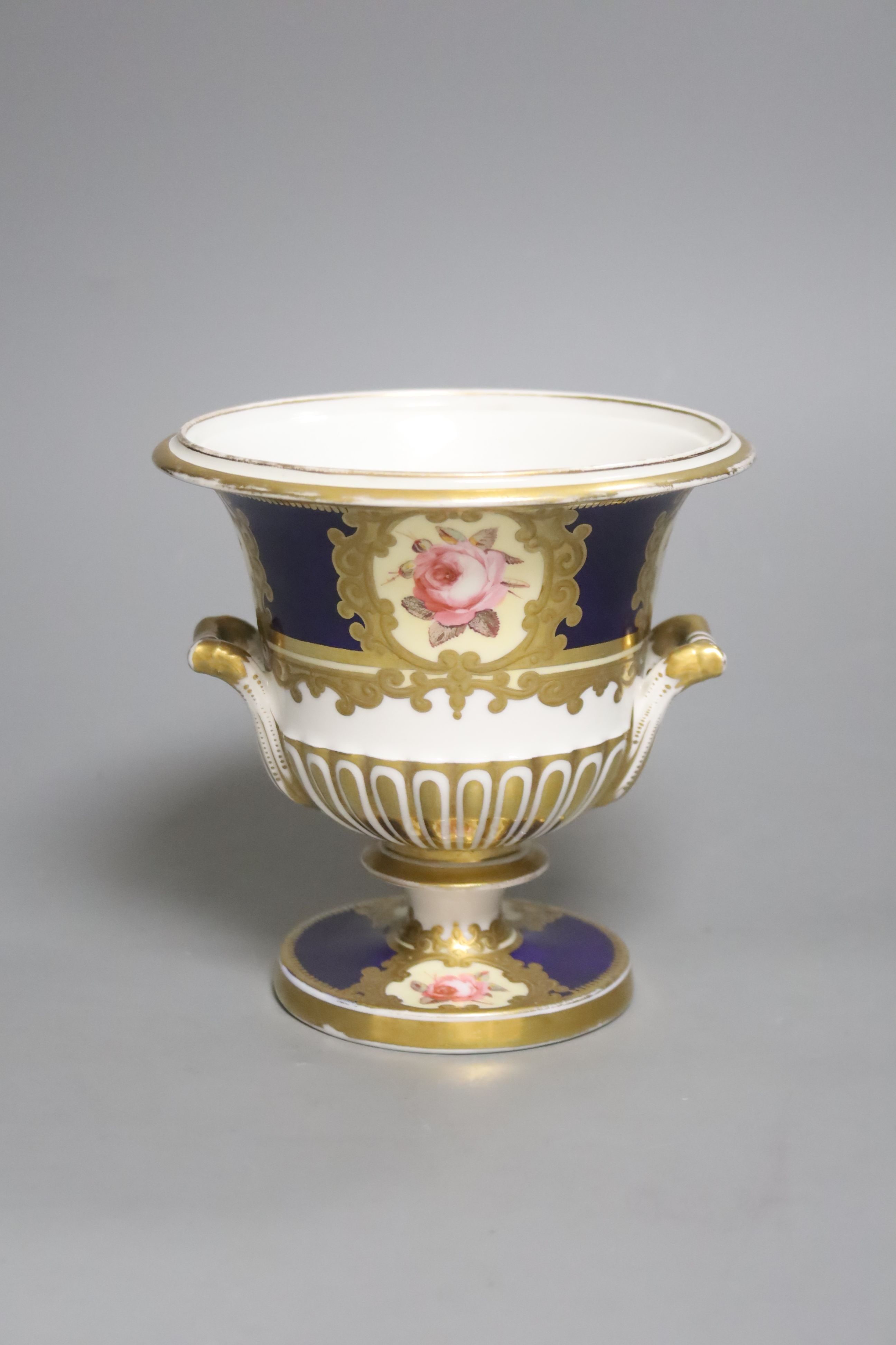 A Chamberlains Worcester two handled vase, painted with six single roses on a blue ground, height 14.5cm